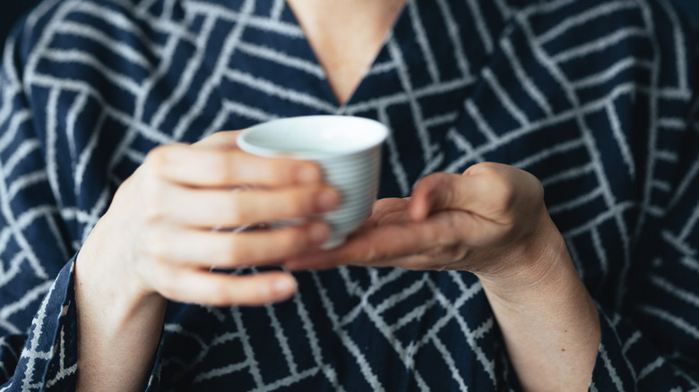 holding japanese tea cup two hands