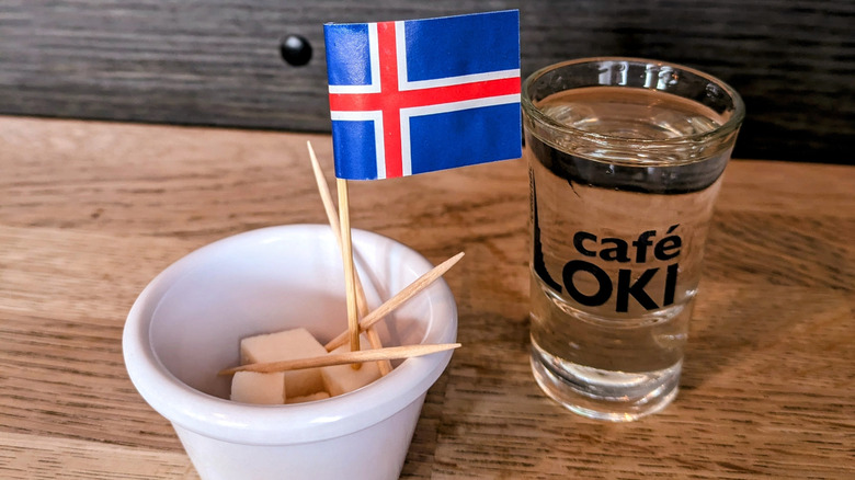 Fermented shark, called Hákarl in Iceland with Iceland flag and glass of white alcohol