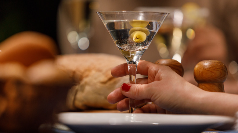 A hand holding a Martini