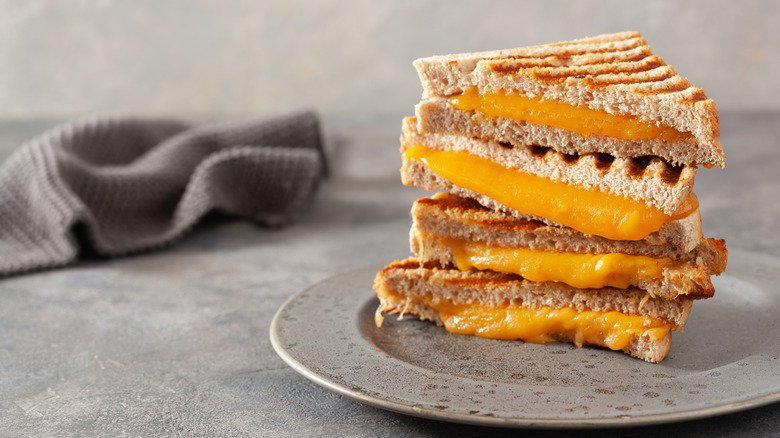 Grilled cheese stacked on plate