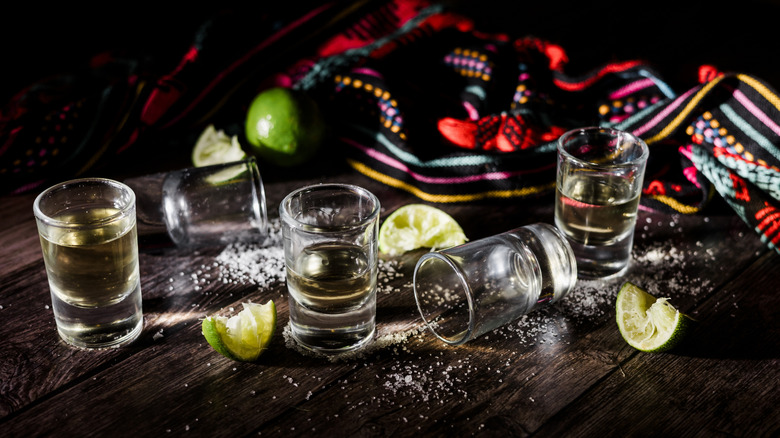 shot glasses with tequila, lime, and salt