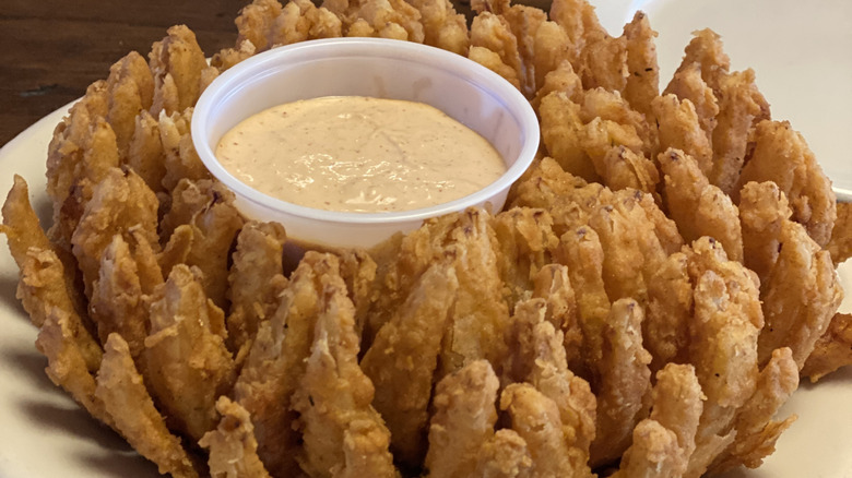 fried onion dish with dipping sauce