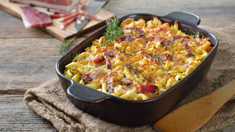 Cheese spaetzle and bacon casserole on table