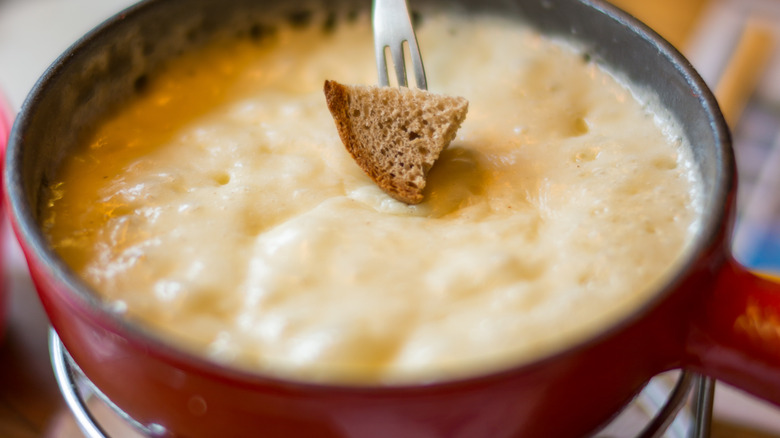 Traditional Swiss cheese fondue in a red pot