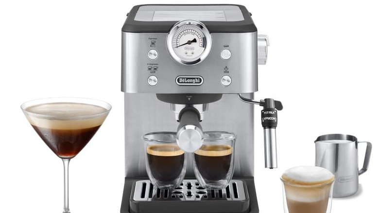 The DeLonghi Classic Espresso Machine with two pulled shots underneath it next to an espresso martini, a latte, and a filled milk jug