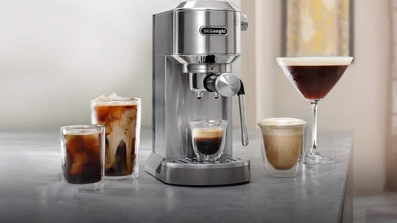 A DeLonghi machine surrounded by different coffees