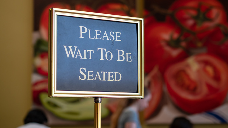 "Please Wait to Be Seated" sign