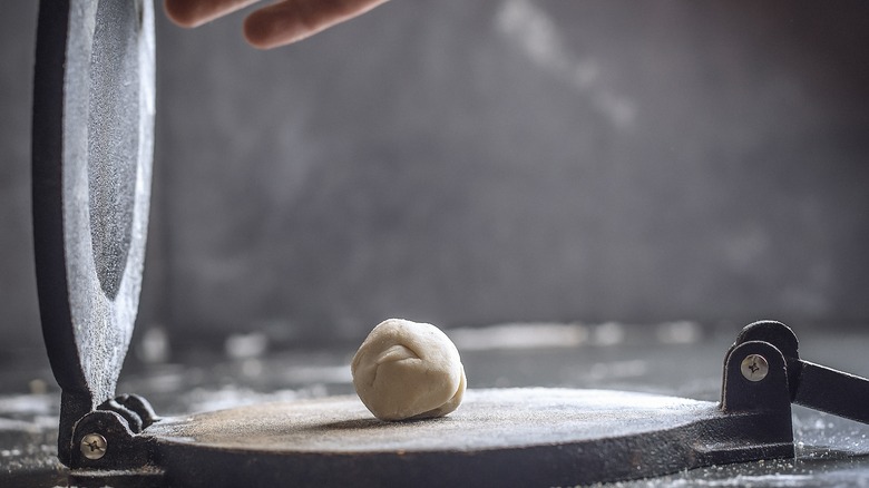 dough on a tortilla press