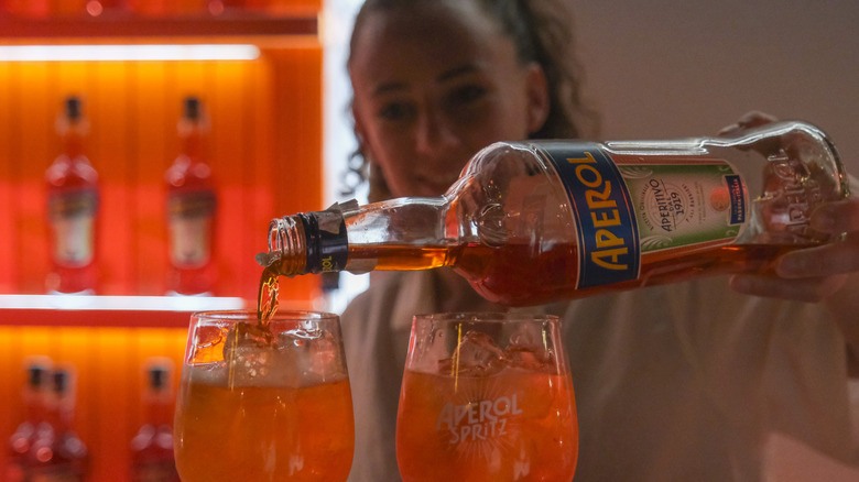 Bartender preparing Aperol Spritz.