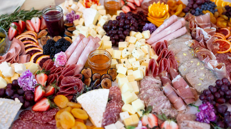 a vibrate charcuterie board with cheese fruit and jams