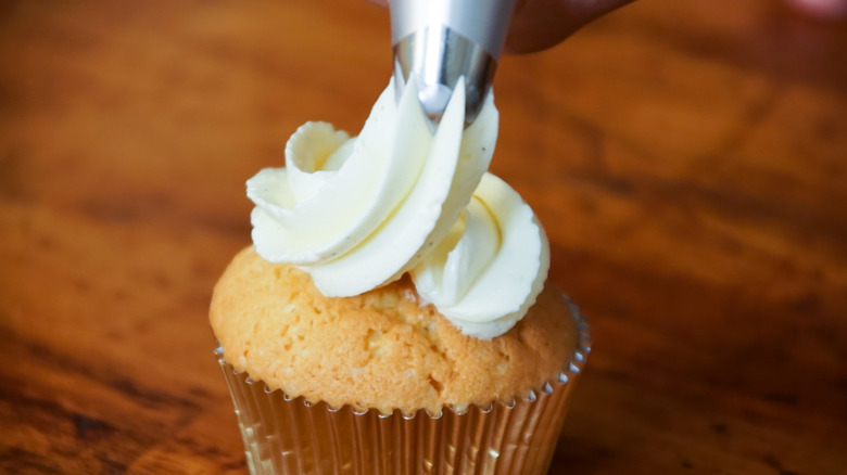 frosting a cupcake