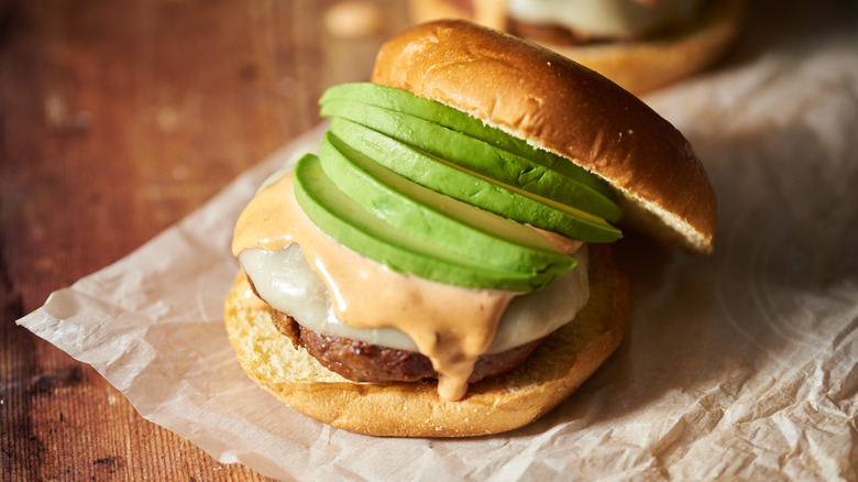 Chipotle burger topped with avocado and cheese