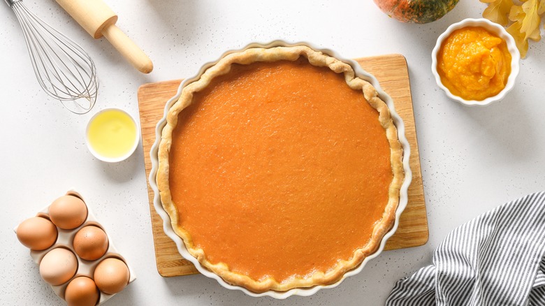 pumpkin pie surrounded by ingredients
