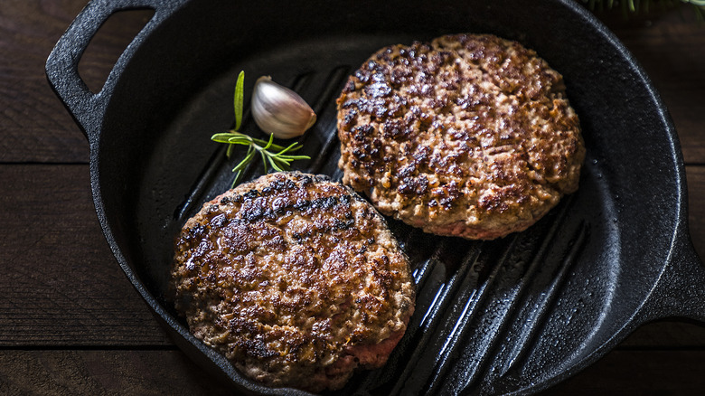 juicy burger patties in cast iron grill pan