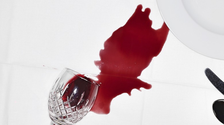 spilled red wine on white tablecloth