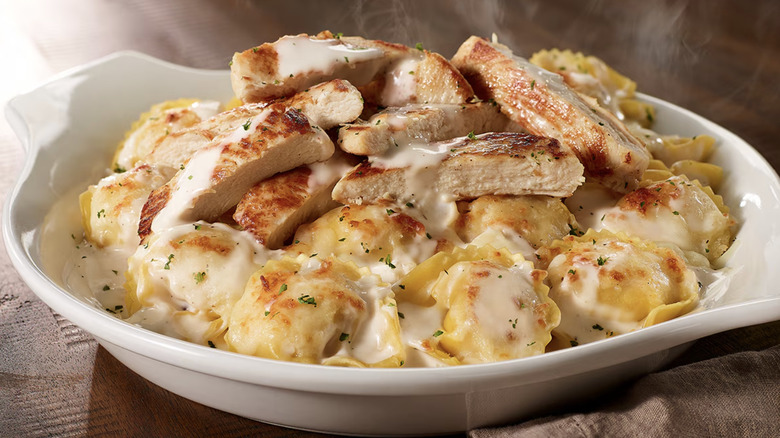 Olive Garden's Tortelloni Alfredo in white bowl with chicken