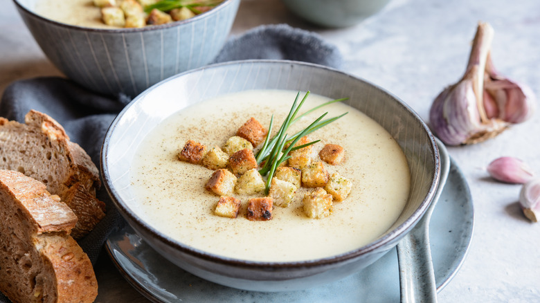 Creamy garlic soup in bowl