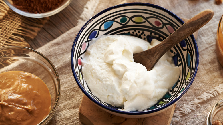 A bowl of Greek yogurt and small bowl of nut butter