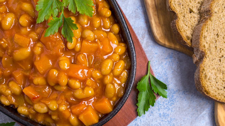 A creamy vegetable soup is topped with fresh cilantro and served next to multigrain slices of toast.