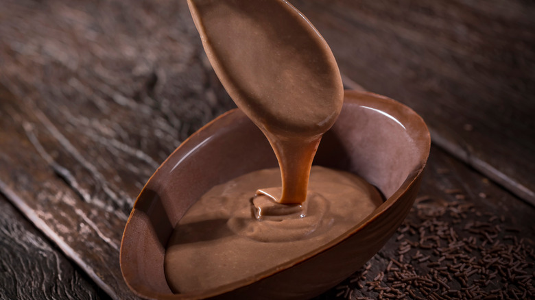 Spoon pouring melted chocolate