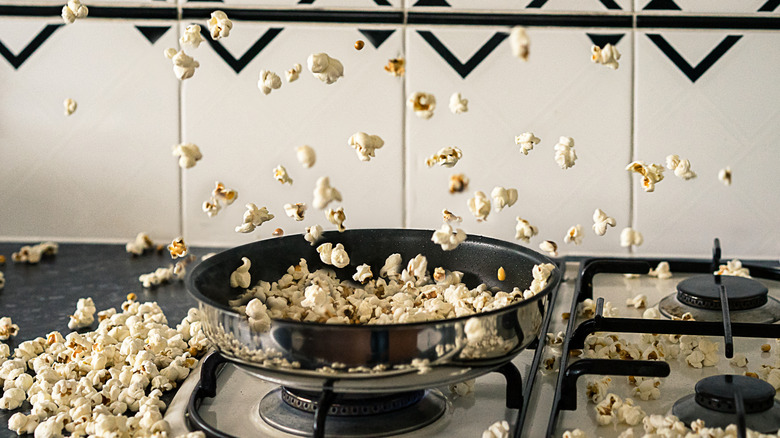 Popcorn pops upward on unlit gas stove