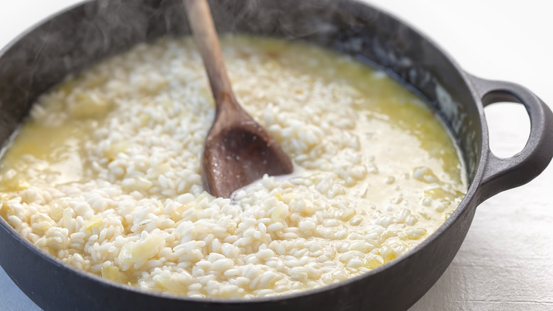 A pan of risotto being stirred