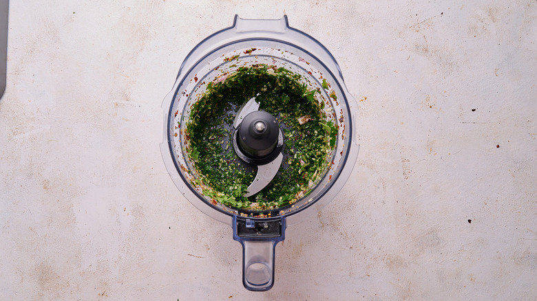 pulsing chimichurri ingredients in food processor