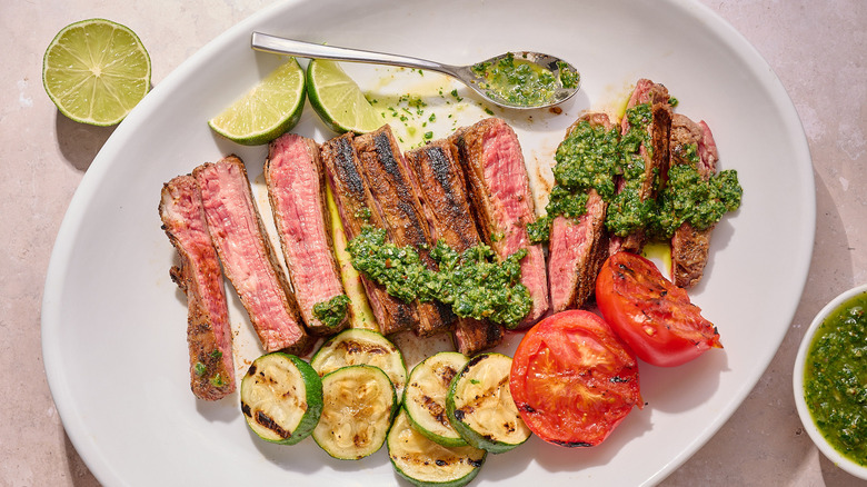 steak and chimichurri on a platter