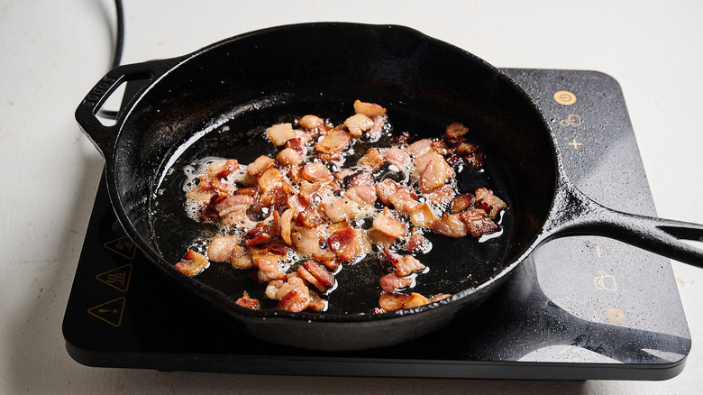 cooking bacon on a skillet on stove