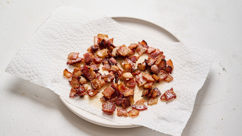 draining bacon on a plate