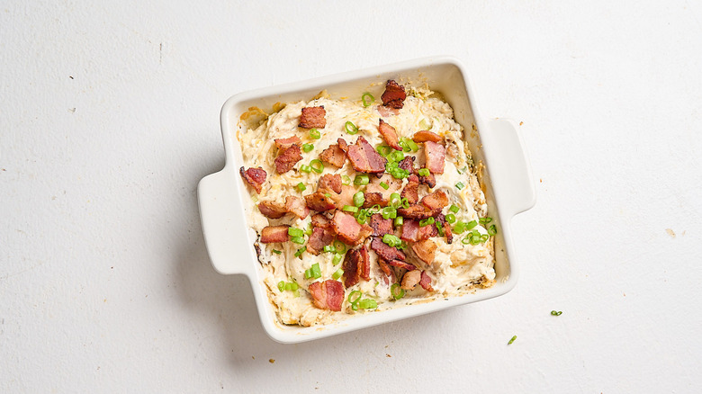 chicken bacon ranch dip garnished with toppings