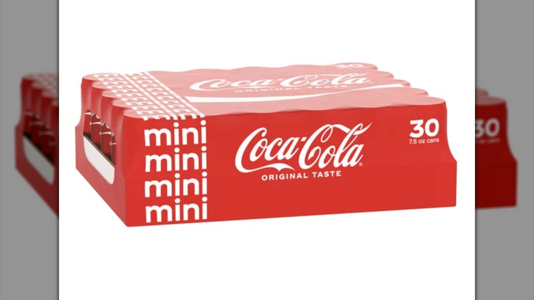 Case of mini Coke cans with white background