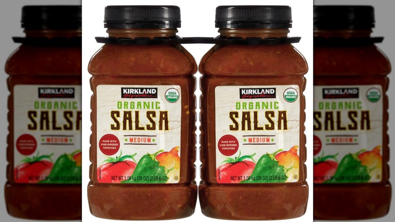 Two jars of Kirkland salsa with white background