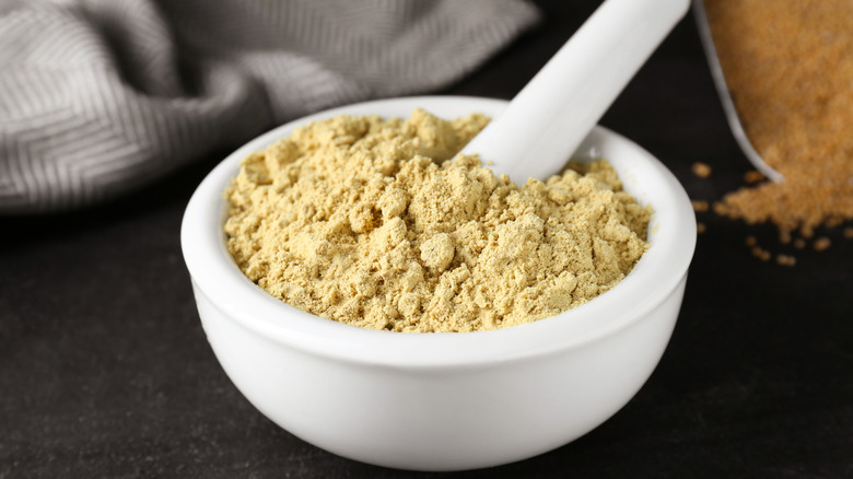 Mortar and pestle filled with mustard powder