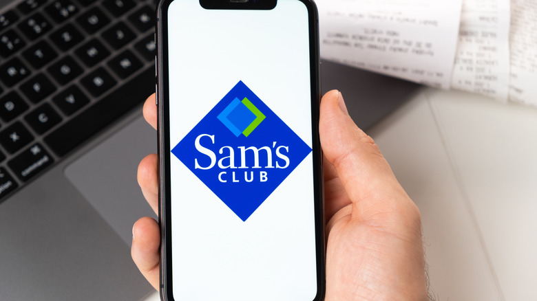 Hand holding Sam's Club app on phone