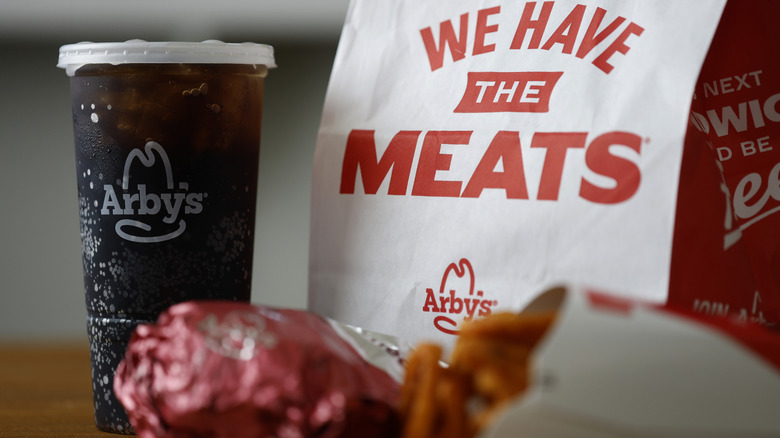 Photo of an Arby's meal with a soda, sandwich, and fries