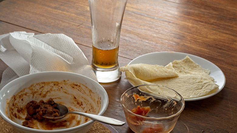 Empty bowl of chili and glass of beer