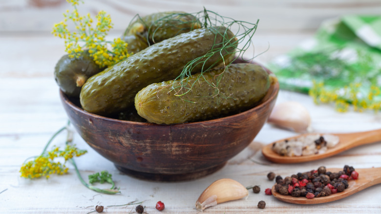 bowl of homemade pickles with dill sprigs