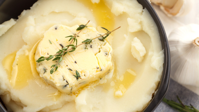 Mashed potatoes in a bowl with herb butter