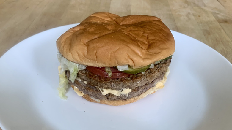 The Sonic SuperSONIC Double Cheeseburger unwrapped on white plate
