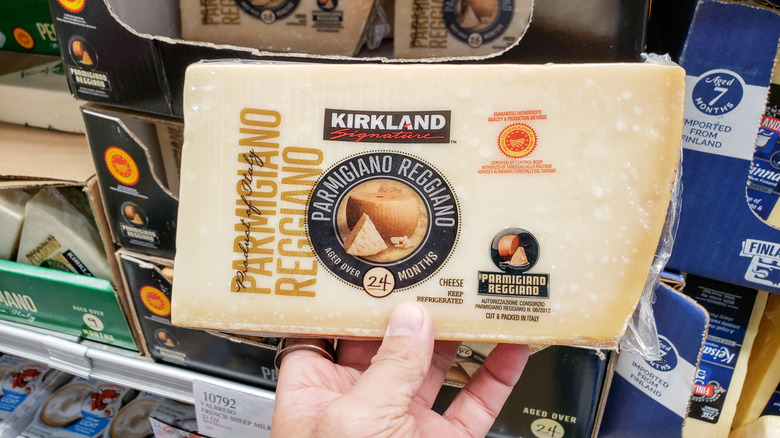 Customer holding Kirkland Signature Parmigiano Reggiano