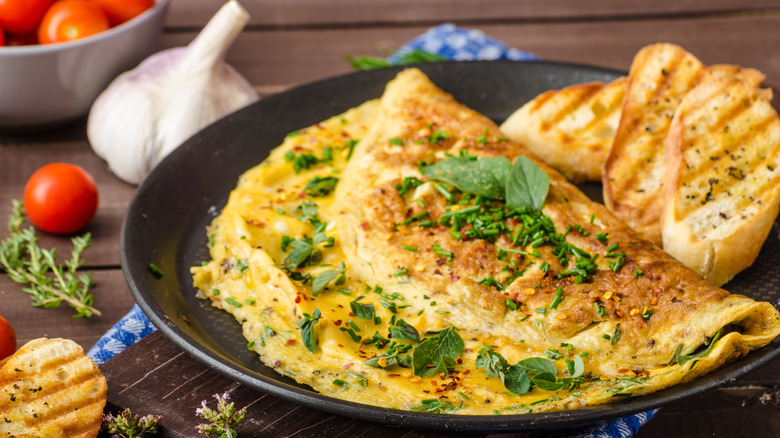 A plate of omelet and toasted bread