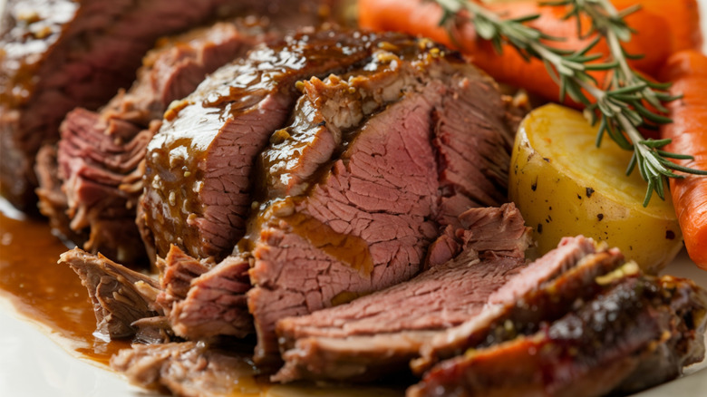 Slow cooked pot roast sliced with vegetables