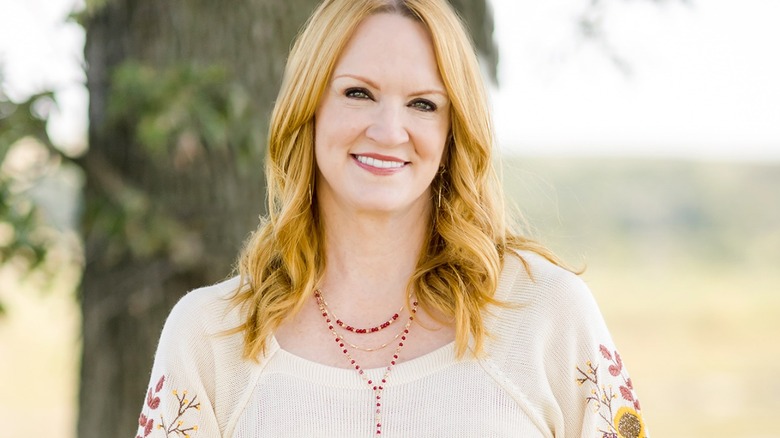 Ree Drummond in white shirt in front of tree 