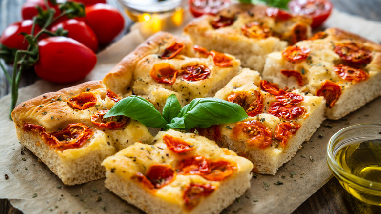 tomato focaccia bread on a cutting board