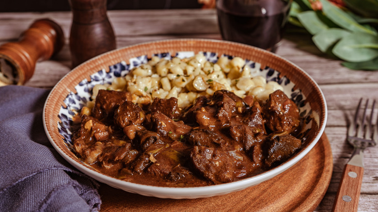 A plate of Hungarian-style goulash, served with spaetzle dumplings