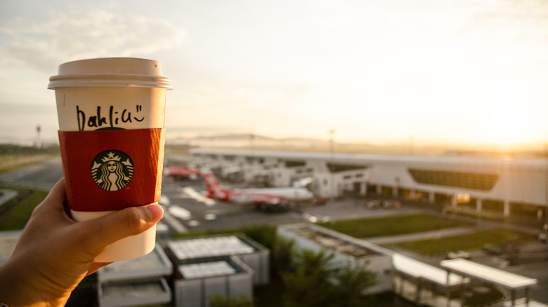 Starbucks cup and airport tarmac