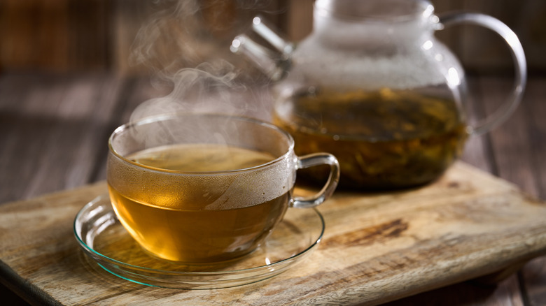 Close-up of green tea steeping in a glass teapot
