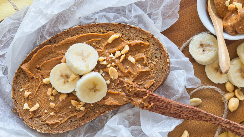 peanut butter spread onto bread with banana