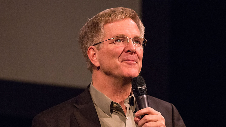 Rick Steves holding a mic